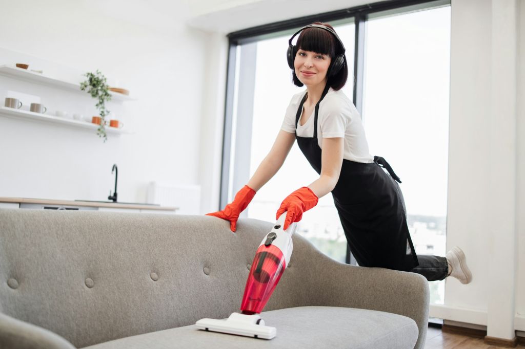 Portrait of employee of cleaning company cleaning in spacious home kitchen